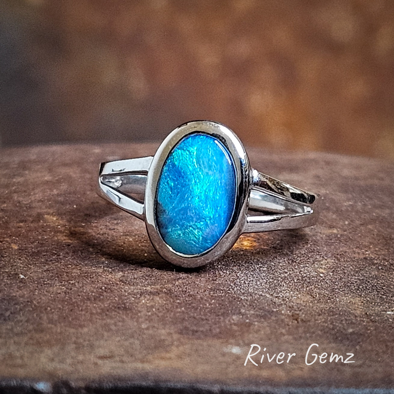 Light blue and dark blue blend in the boulder opal set in sterling silver ring.