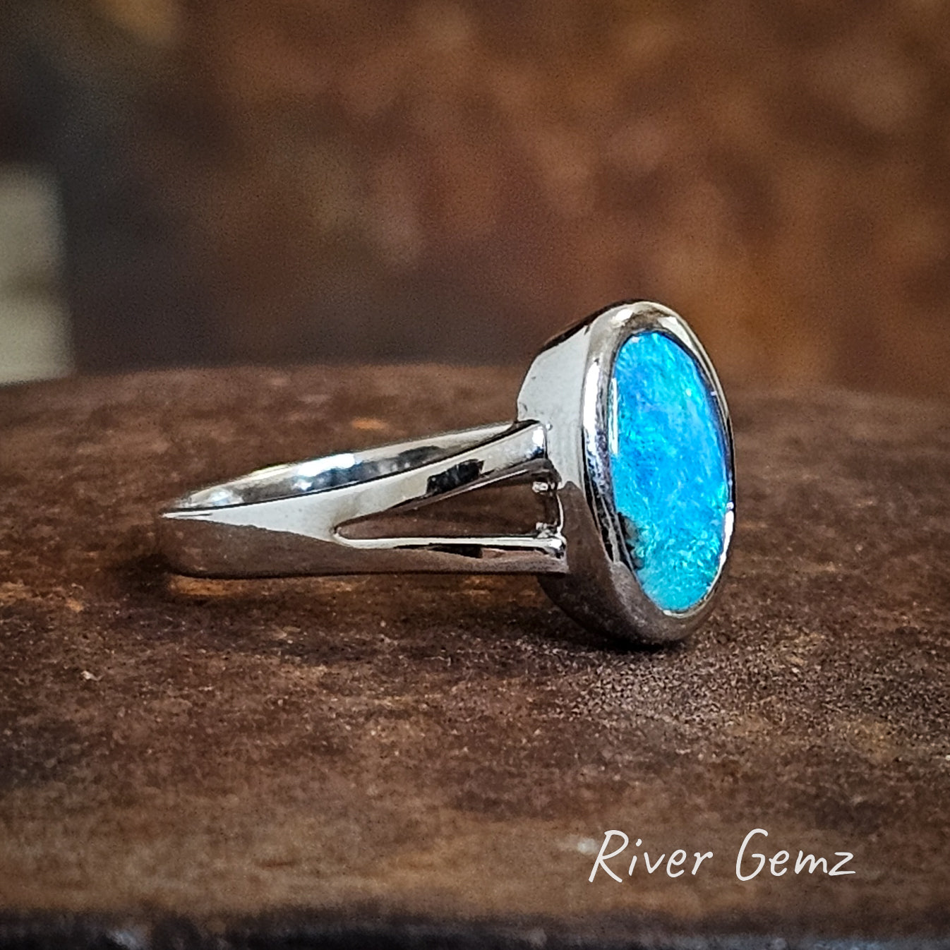 Side view of the ring shows the depth of the opal and the prong design of the silver ring setting.