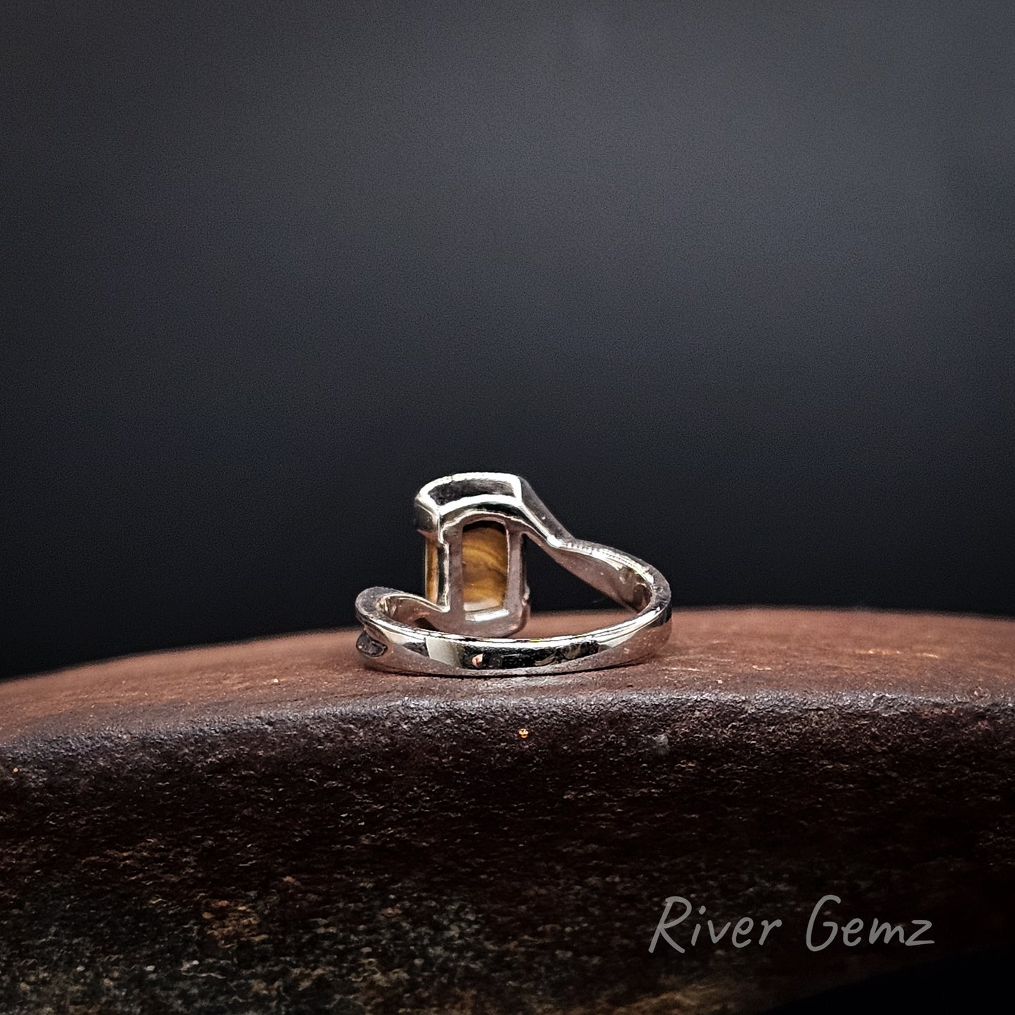 Rear view of the silver ring showing the ironstone matrix of the boulder opal set in it. The brand name 'River Gemz' is visible in the bottom right corner.
