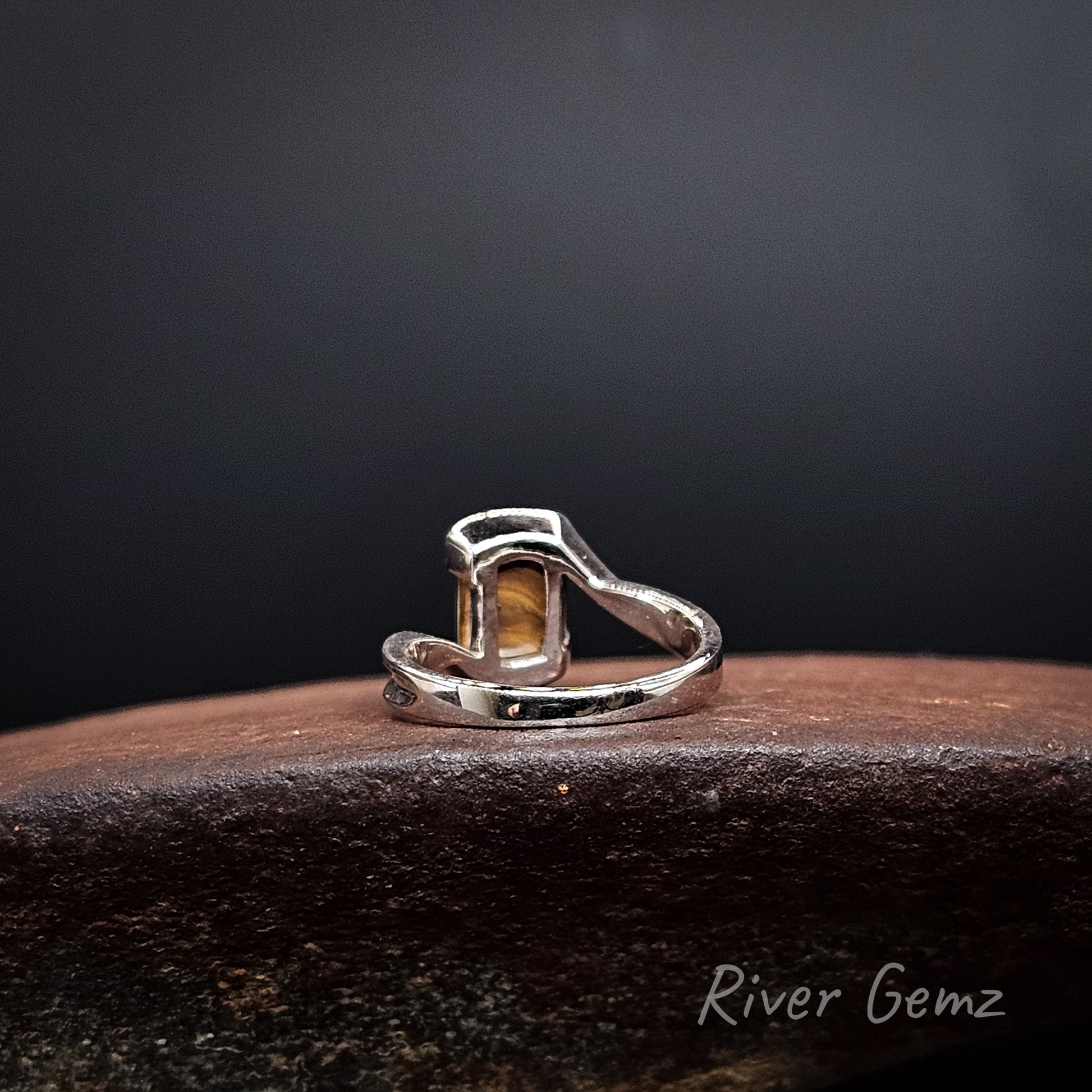 Rear view of the silver ring showing the ironstone matrix of the boulder opal set in it. The brand name 'River Gemz' is visible in the bottom right corner.