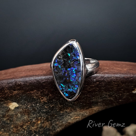 Large blue and purple dark opal besel set in silver ring.