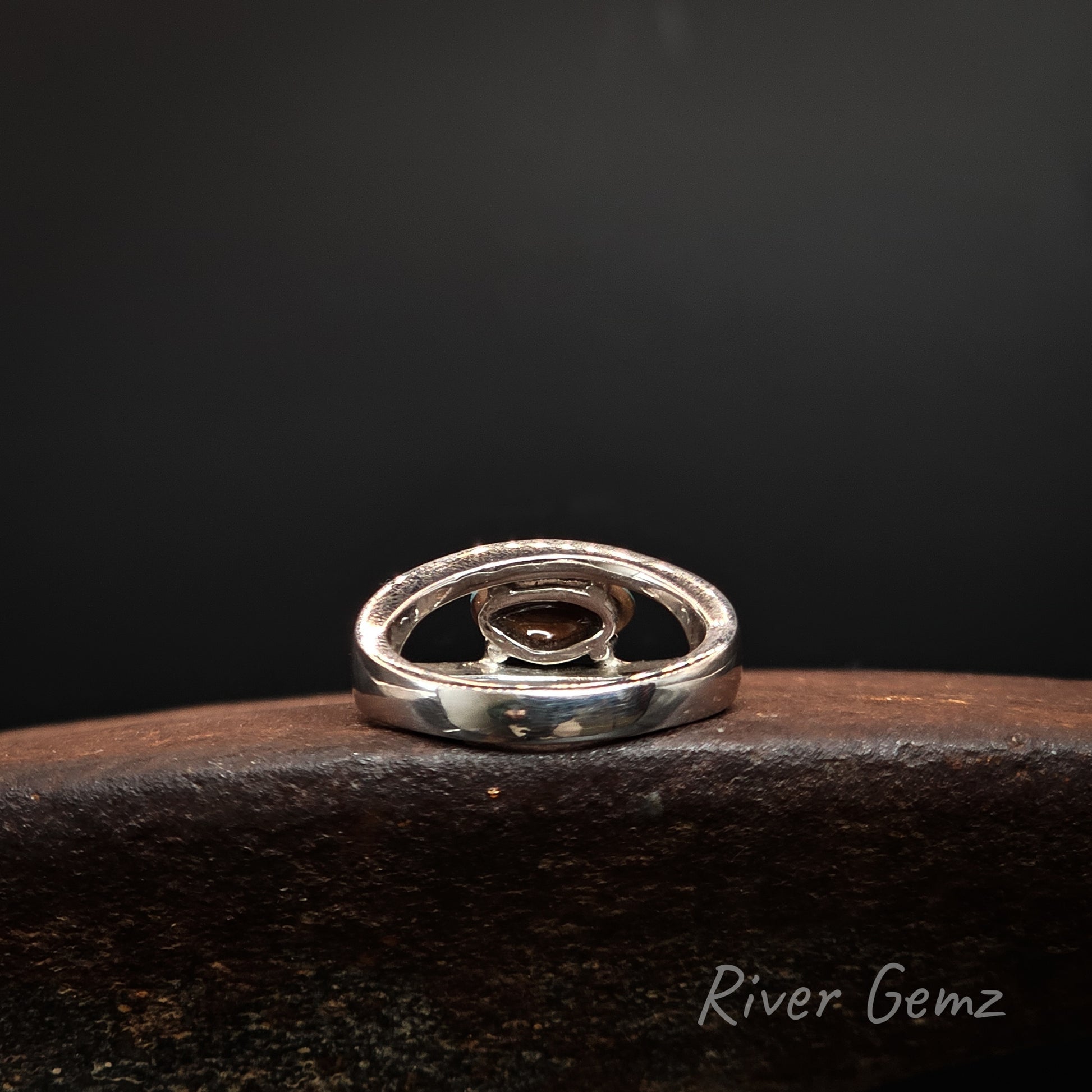 Rear view of the silver ring shows the ironstone matrix of the boulder opal set in it. The brand name 'River Gemz' is visible in the bottom right corner.
