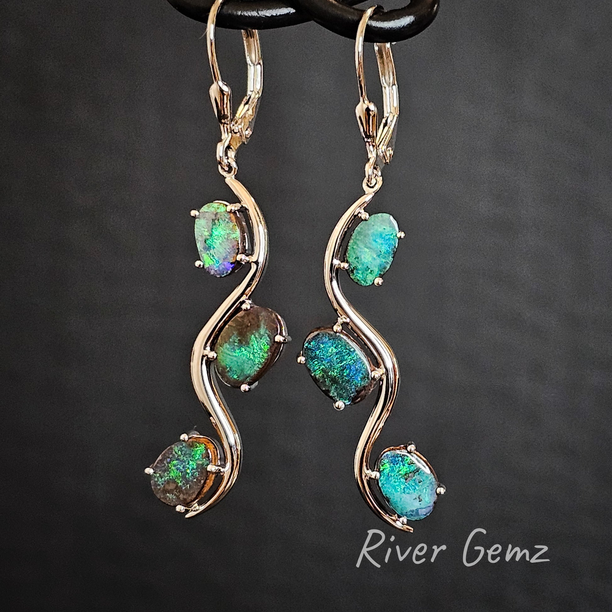 Green boulder opals claw set in sterling silver hook earrings.