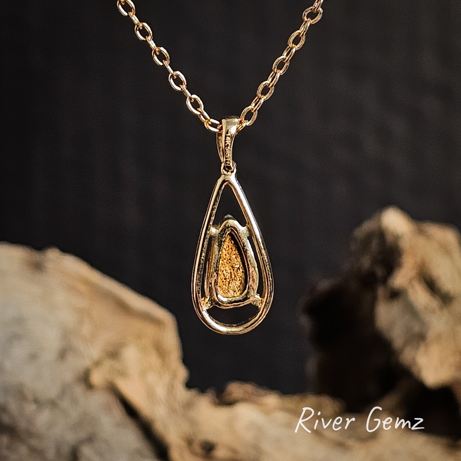 Rear view of the gold necklace shows the light toned ironstone matrix of the crystal boulder opal on a dark background with 'River Gemz' branding.