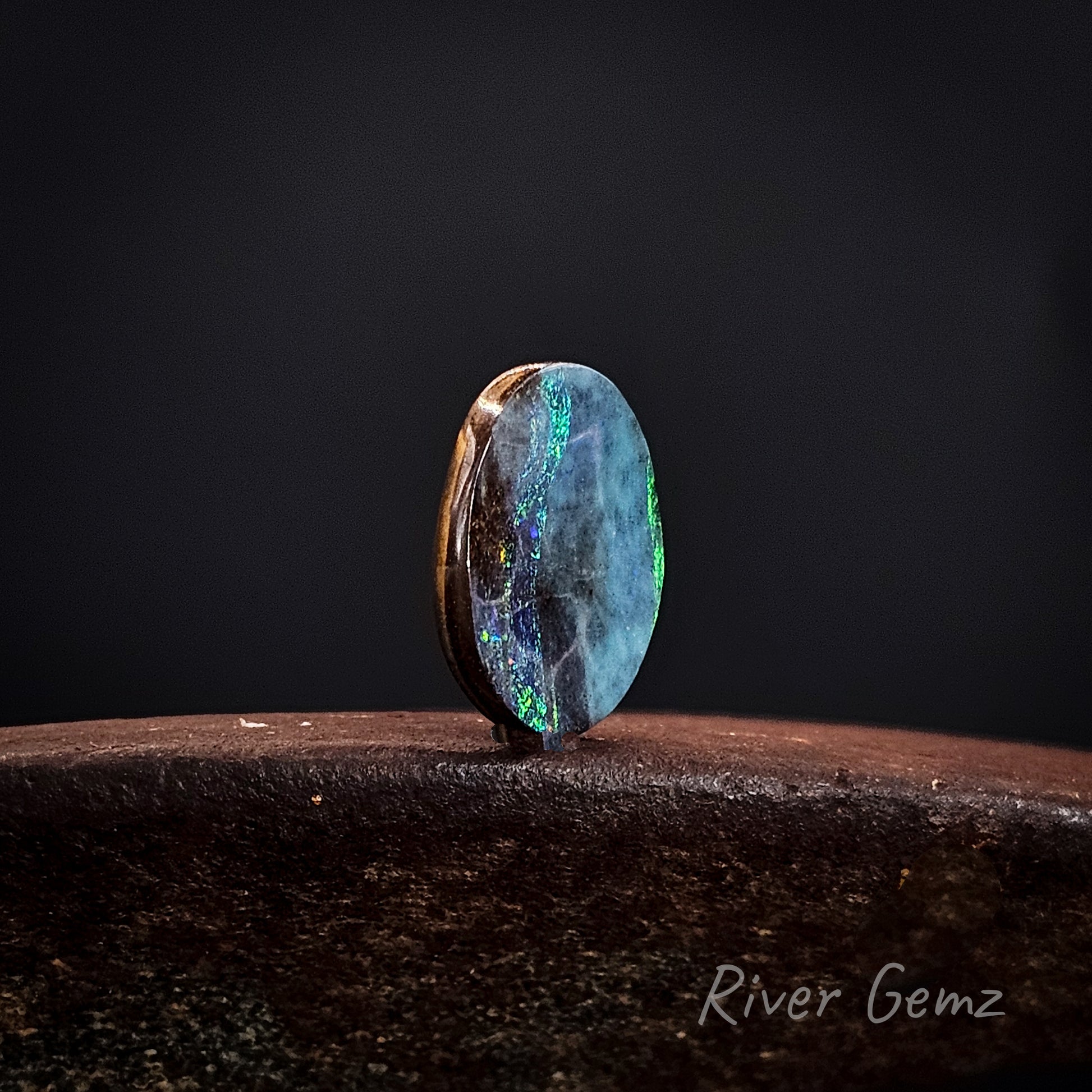 Opal stone on a dark background with 'River Gemz' branding.