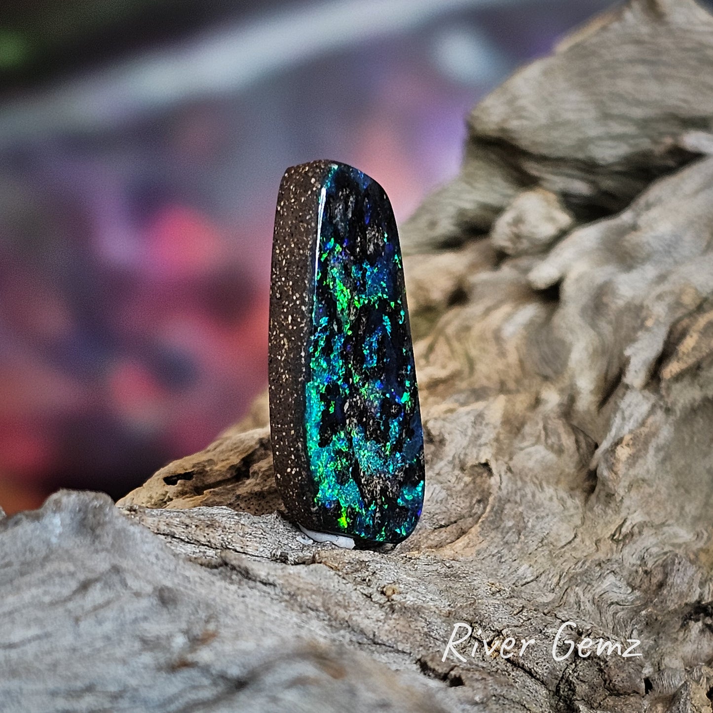 Skewed view shows the thickness and the ironstone host of this large pendant opal stone.