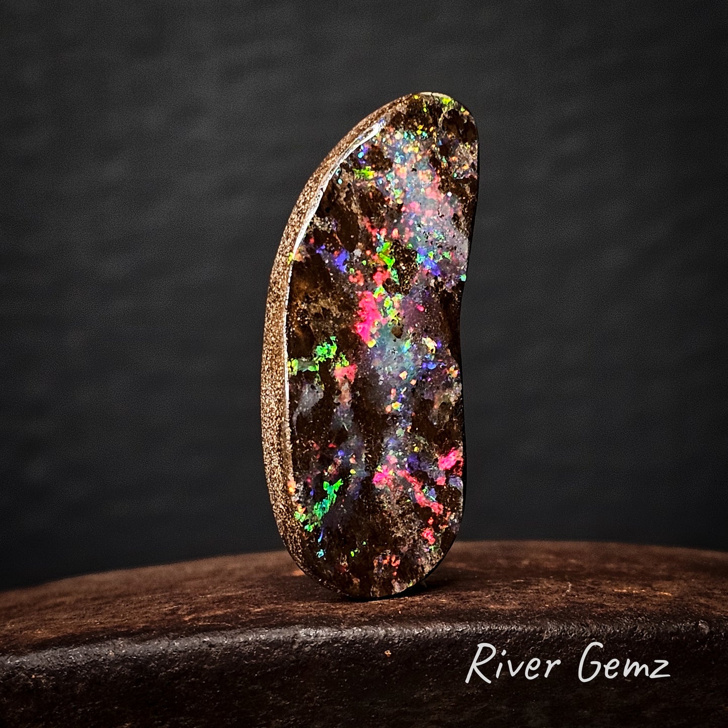 Large free-form cut multi-coloured unset boulder opal.