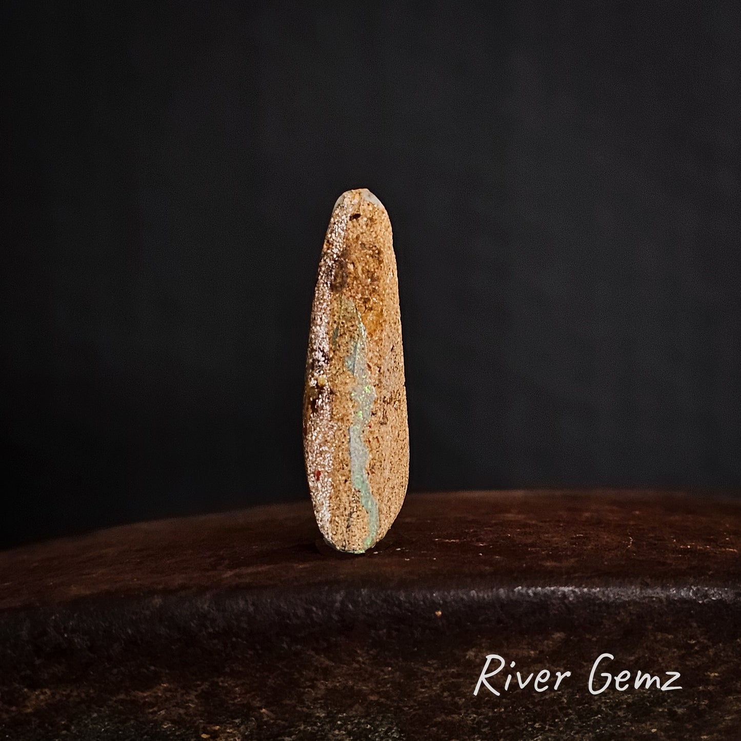 Rear view of the stone showing the light colouration of the pipe opal.