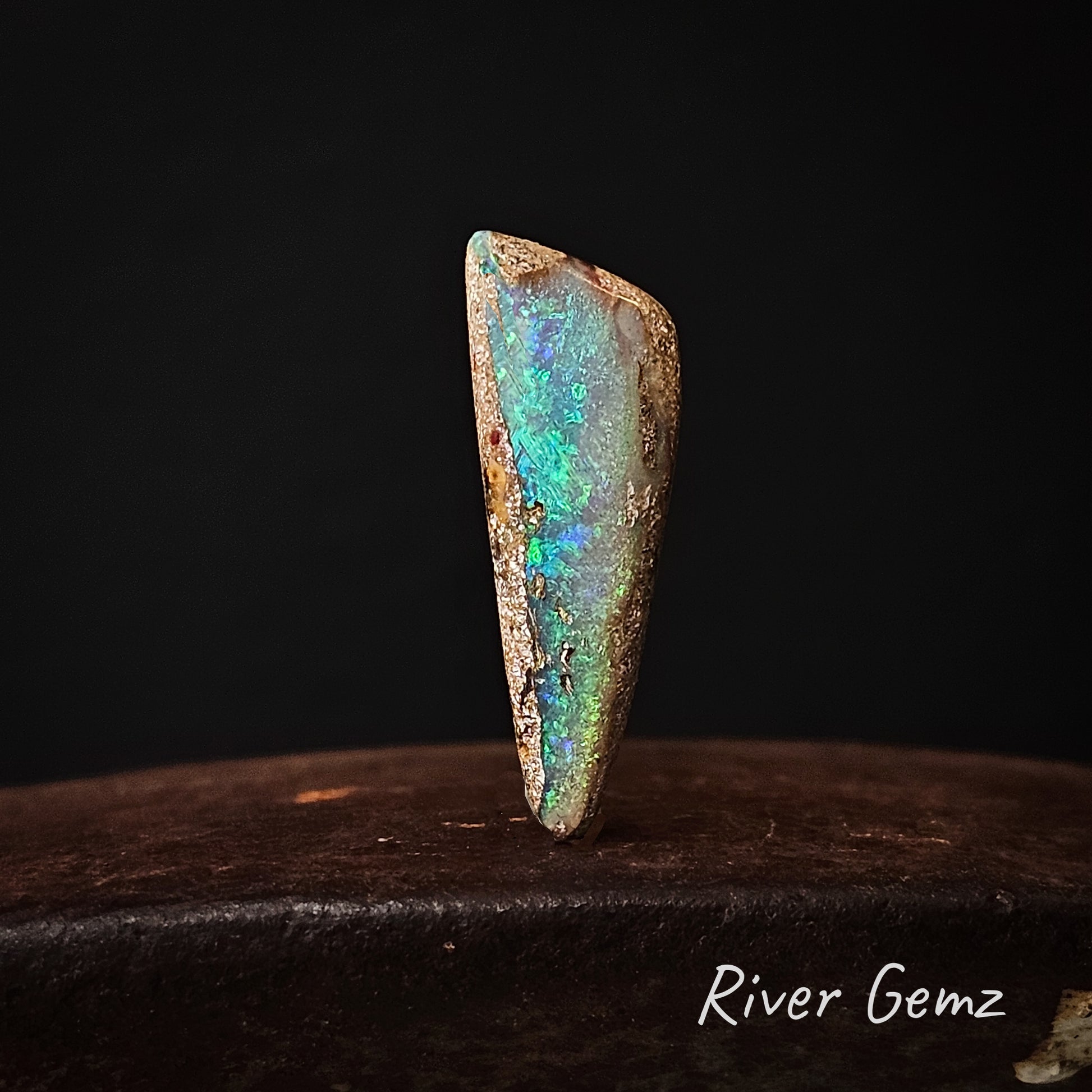 Large triangular shaped pendant stone with blue and green colouration.