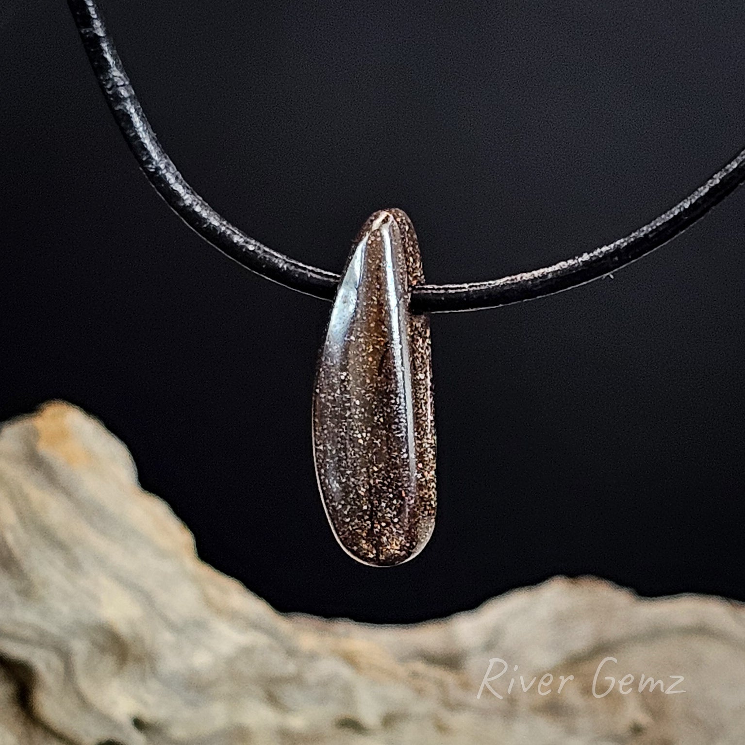 Rear view of the boulder opal pendant on leather.