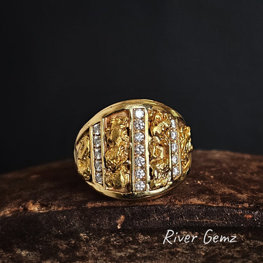 Gold ring with lines of nuggets and lines of diamonds on a dark background.