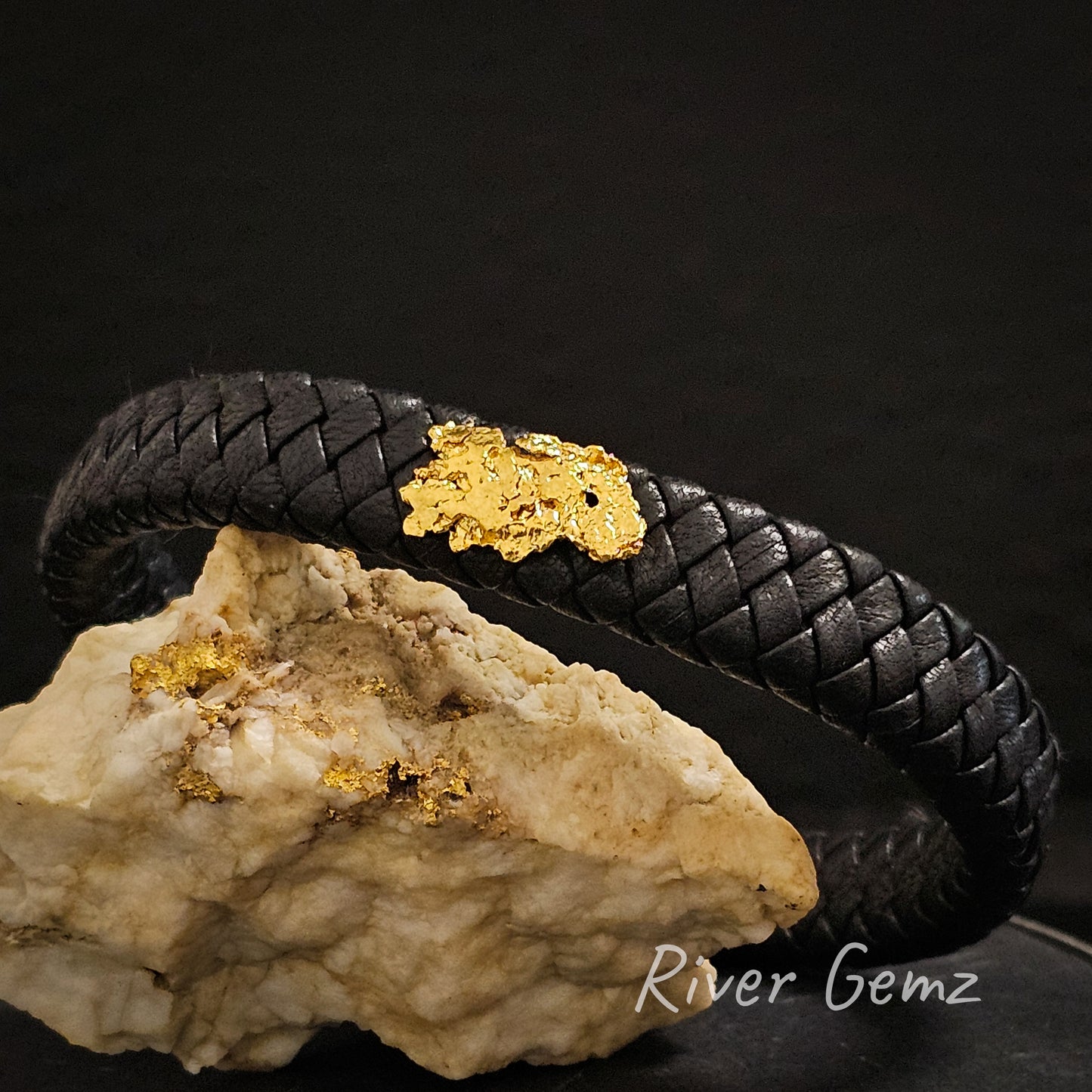 Bright yellow natural nugget featured on a interwoven black leather bracelet.