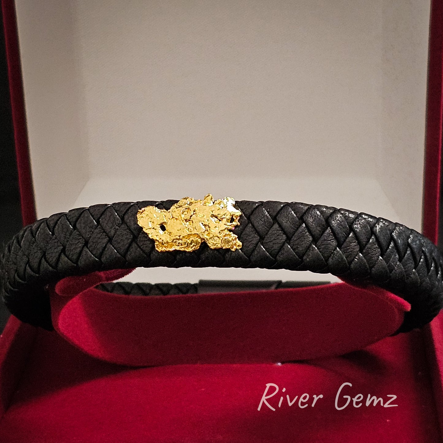 Leather and gold nugget bracelet shown in red velvet jewellery display box.