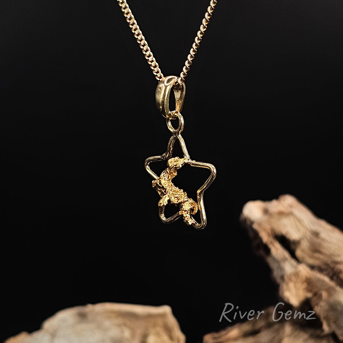 Star shaped yellow gold pendant with a natural gold nugget at it's heart on a gold chain.