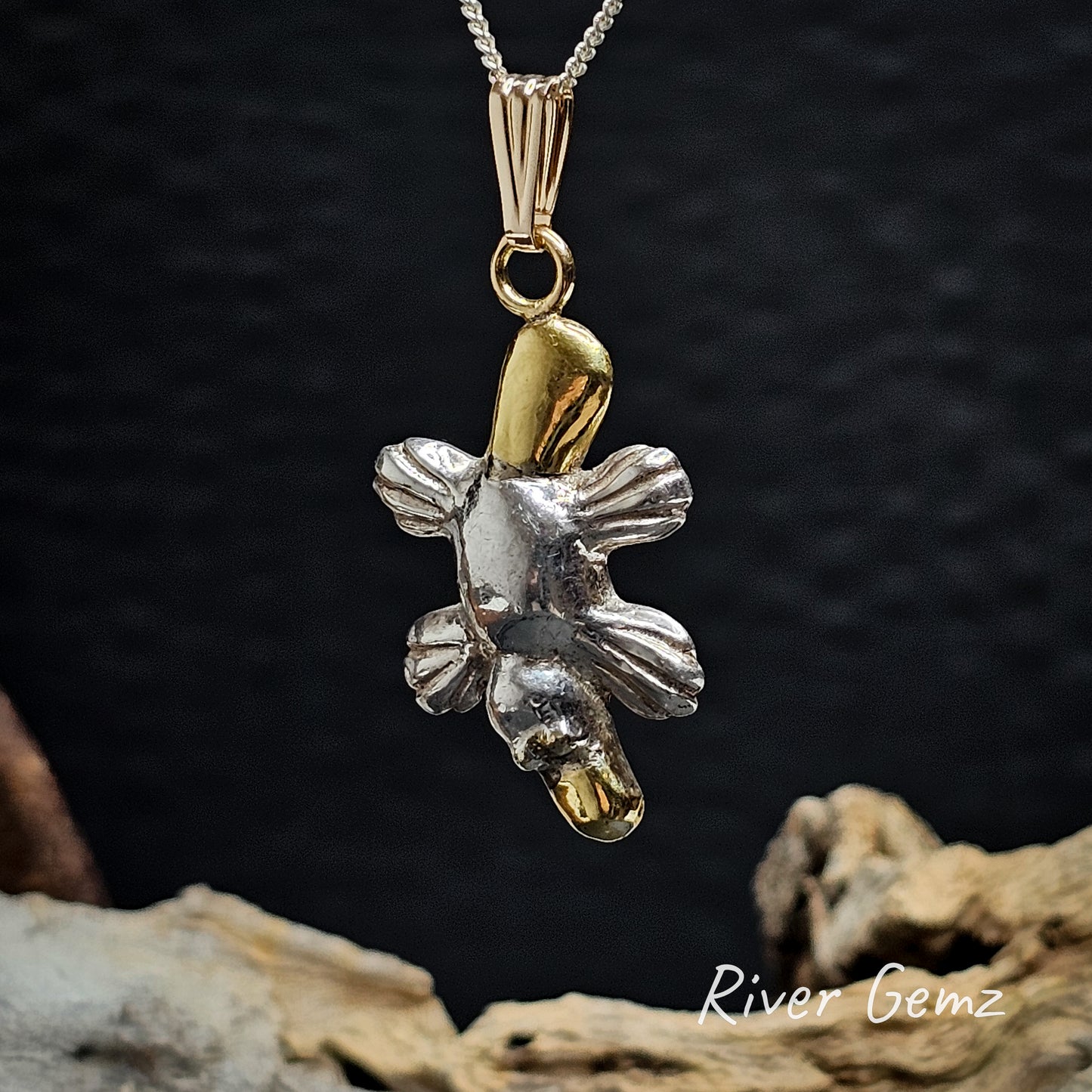 Platypus pendant on a dark background with 'River Gemz' branding.
