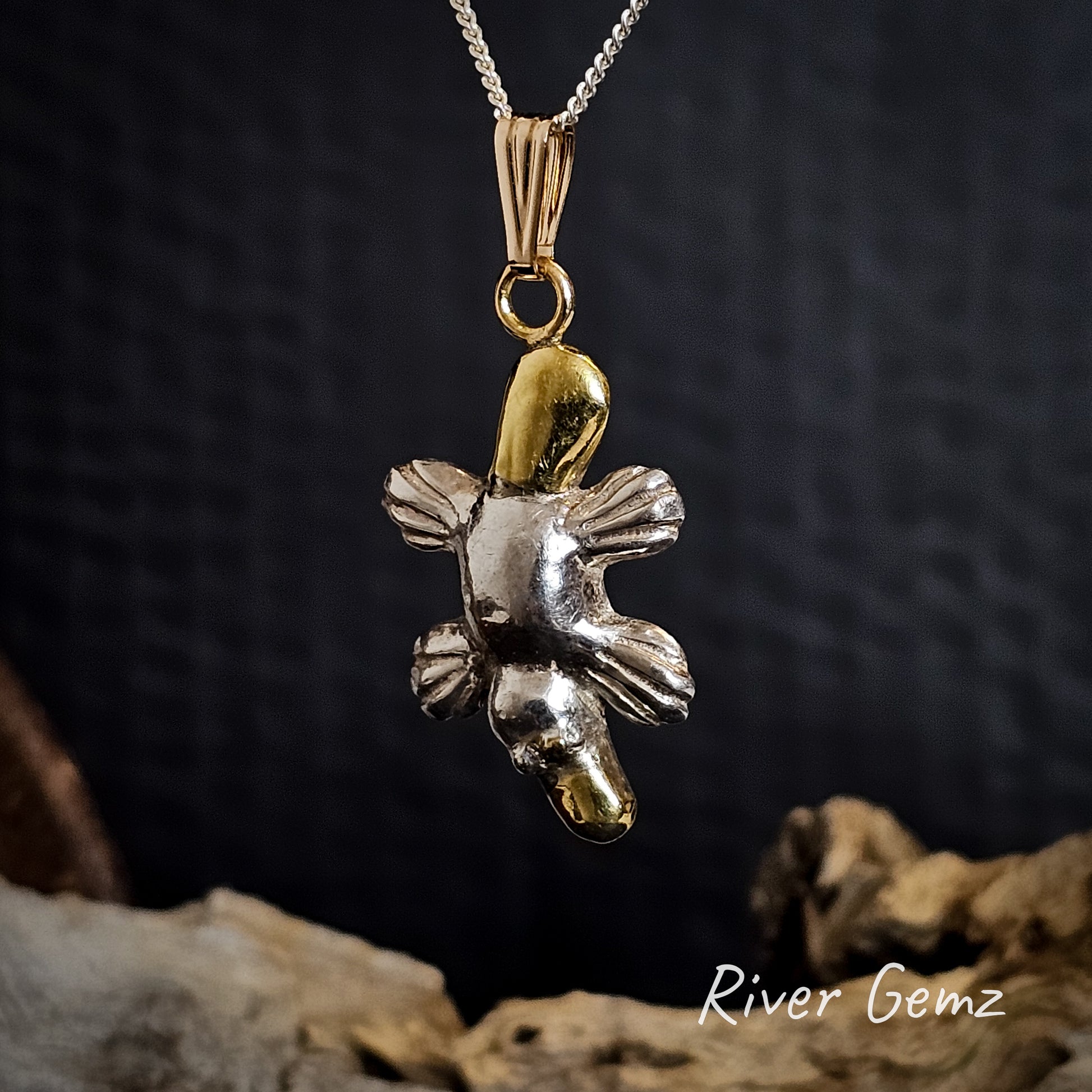 Platypus necklace in a combination of sterling silver and gold.