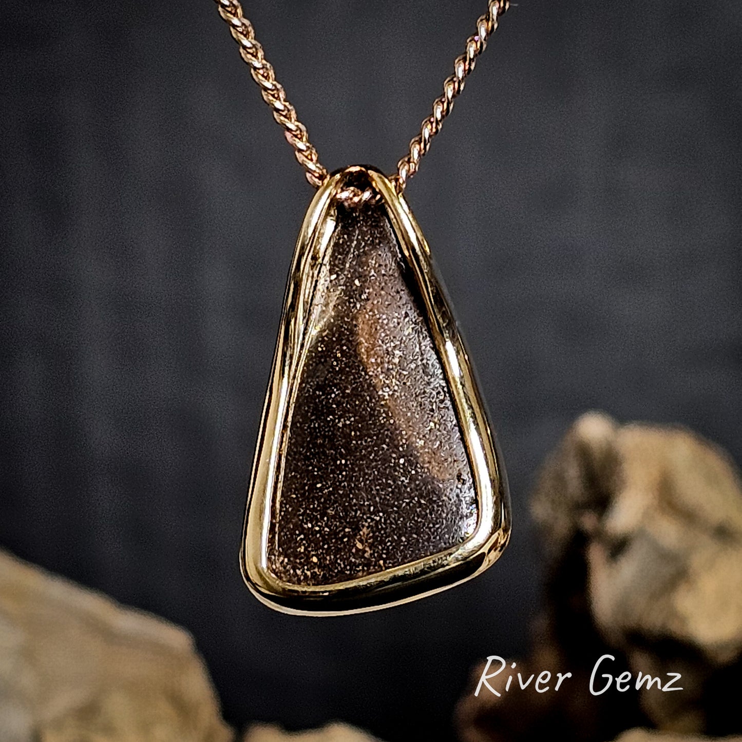 Rear view of gold necklace shows the ironstone matrix of the boulder opal.