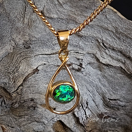 Vivid green and blue round opal besel set in tear drop shaped yellow gold necklace.