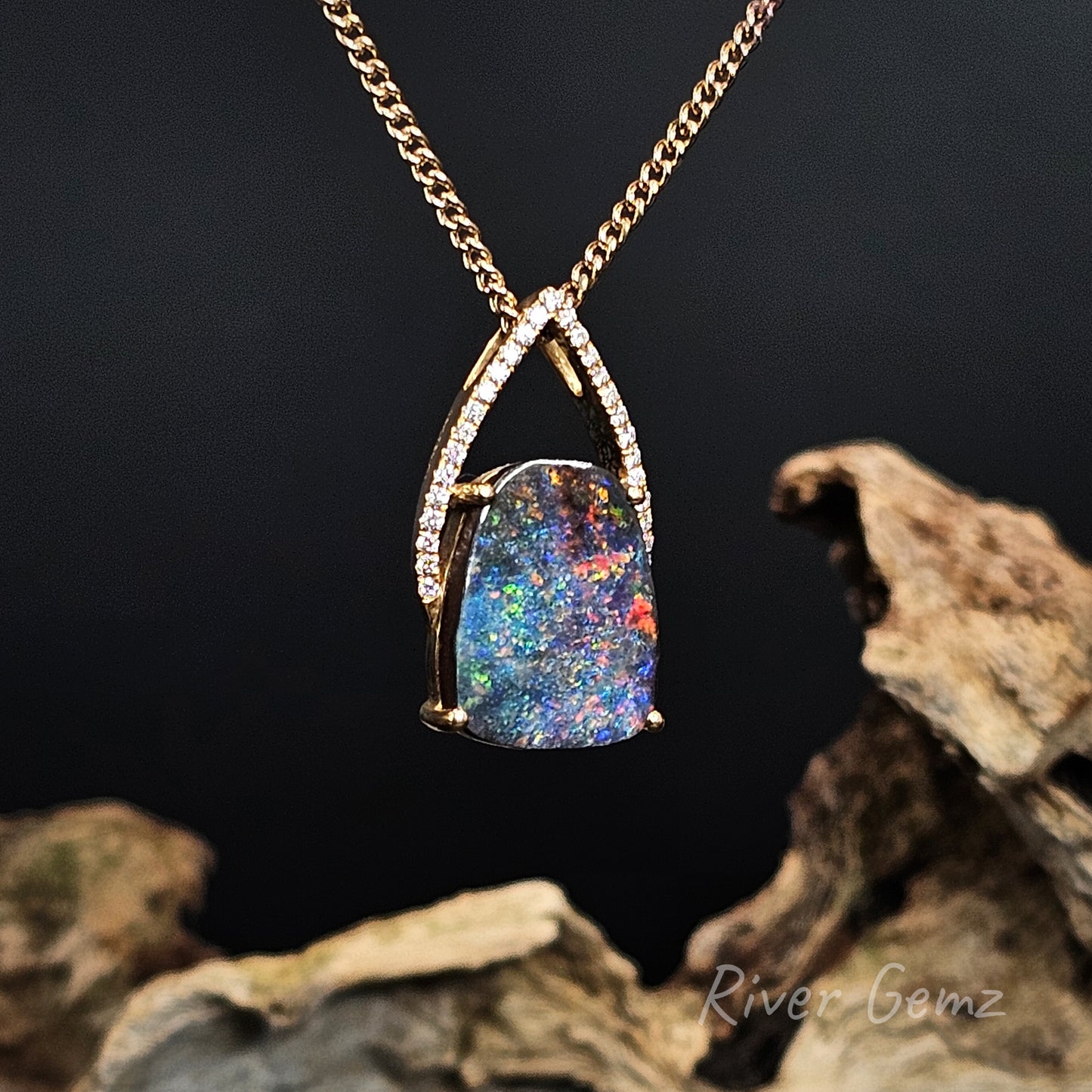 Multi-coloured opal and multiple diamonds set in yellow gold necklace on a dark background with 'River Gemz' branding.