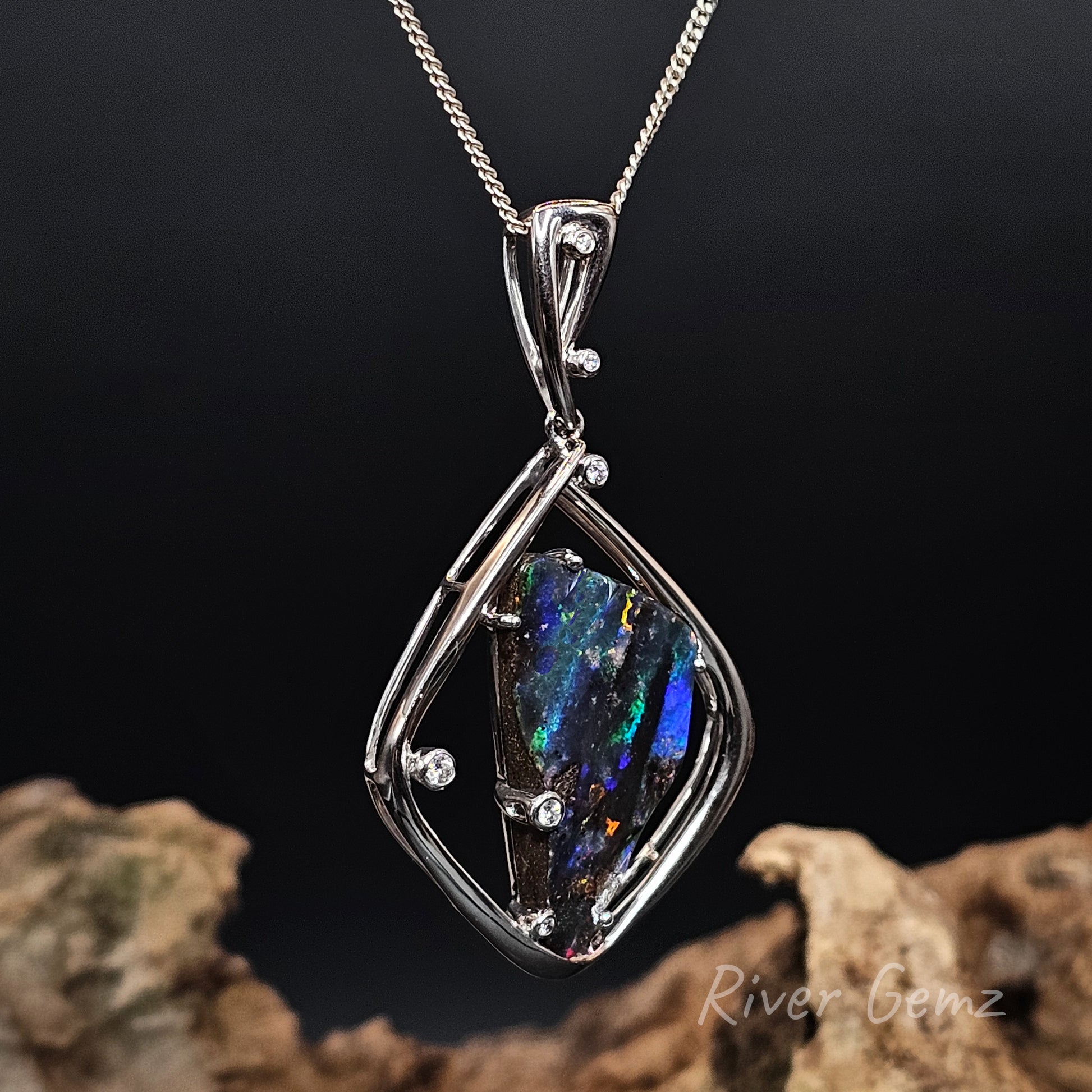 Opal set in white gold necklace on a dark background with 'River Gemz' branding.