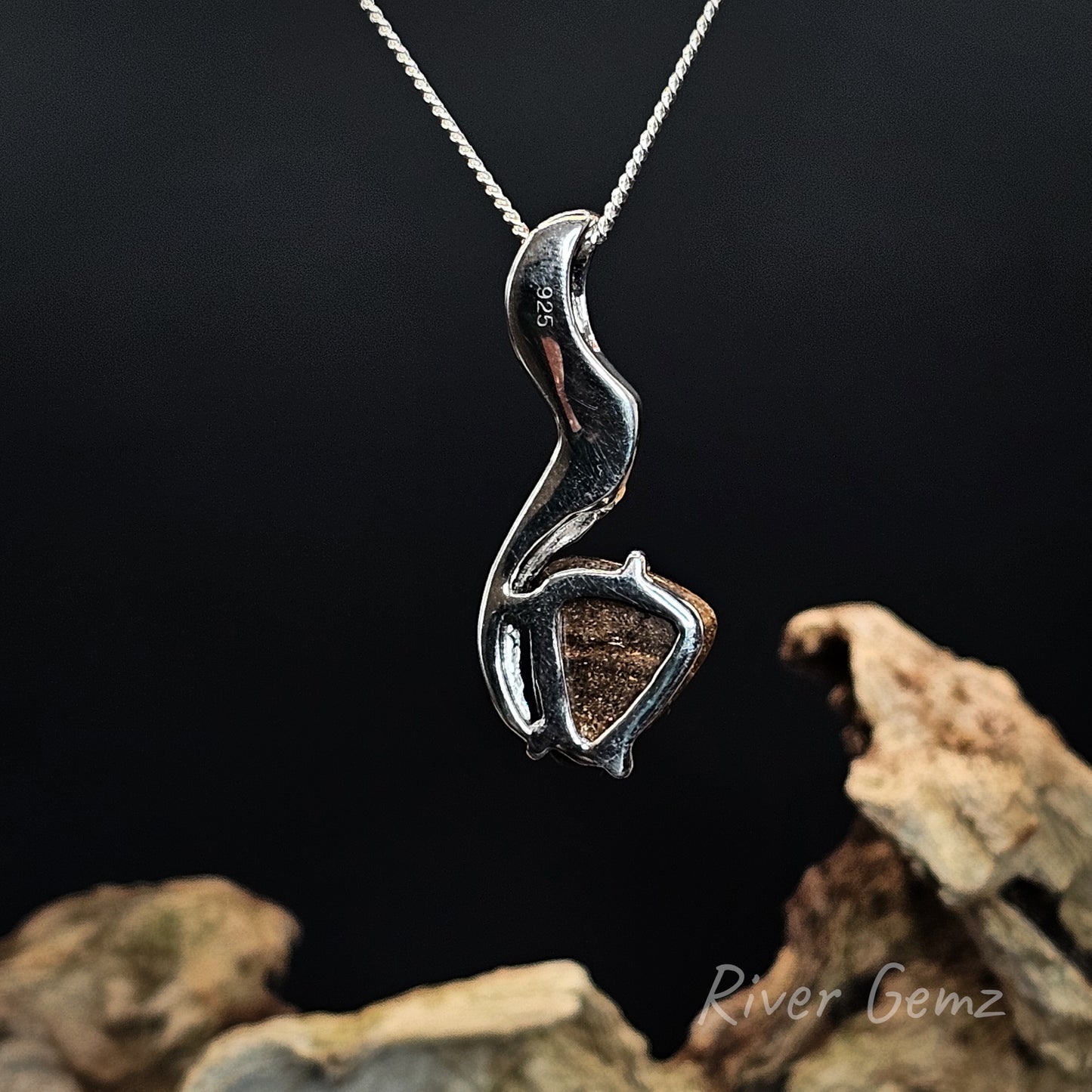 Rear view of necklace shows the ironstone matrix of the boulder opal set in the silver pendant.