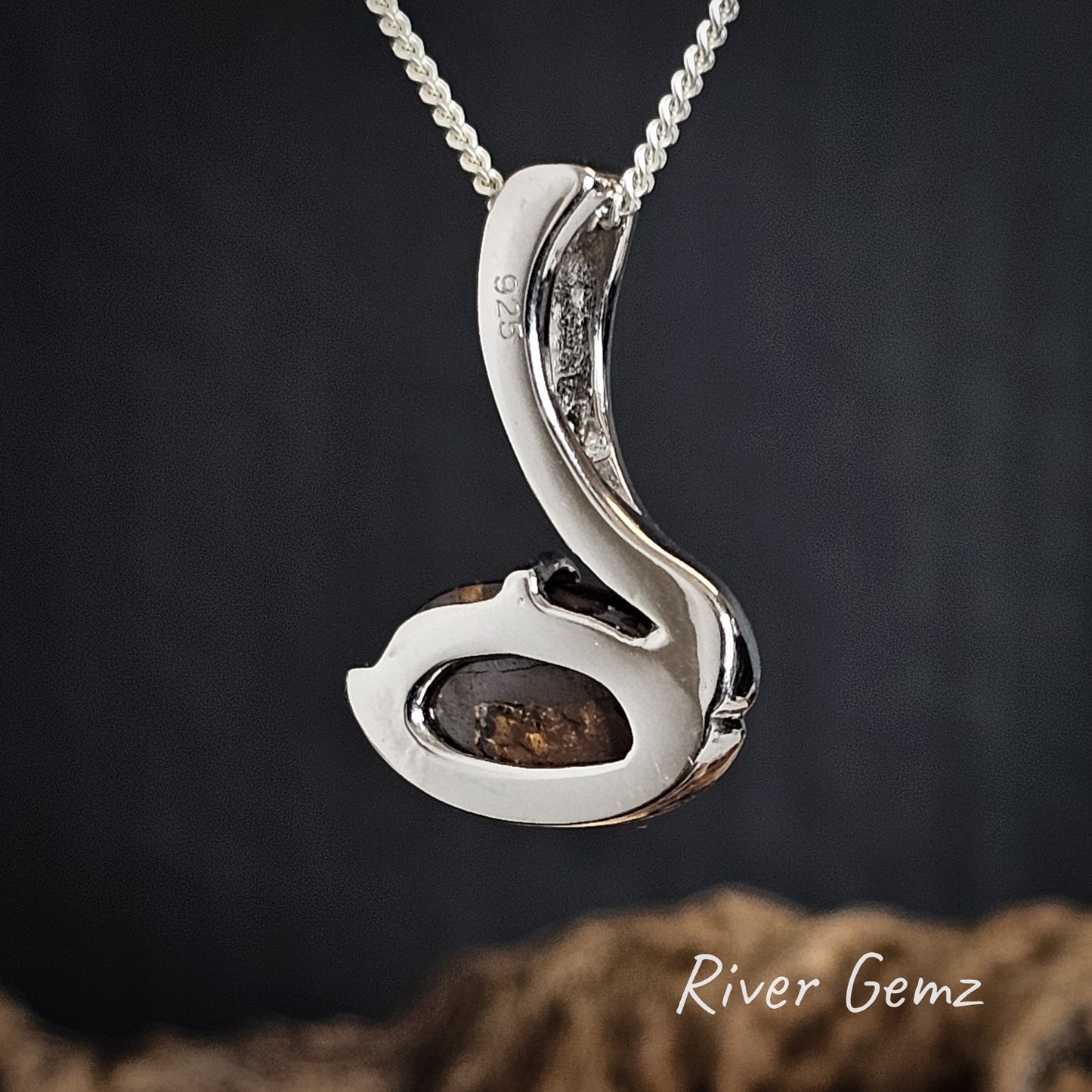 Rear of silver pendant showing the 925 mark to indicate sterling silver with a natural stone on a dark background, branded 'River Gemz'.