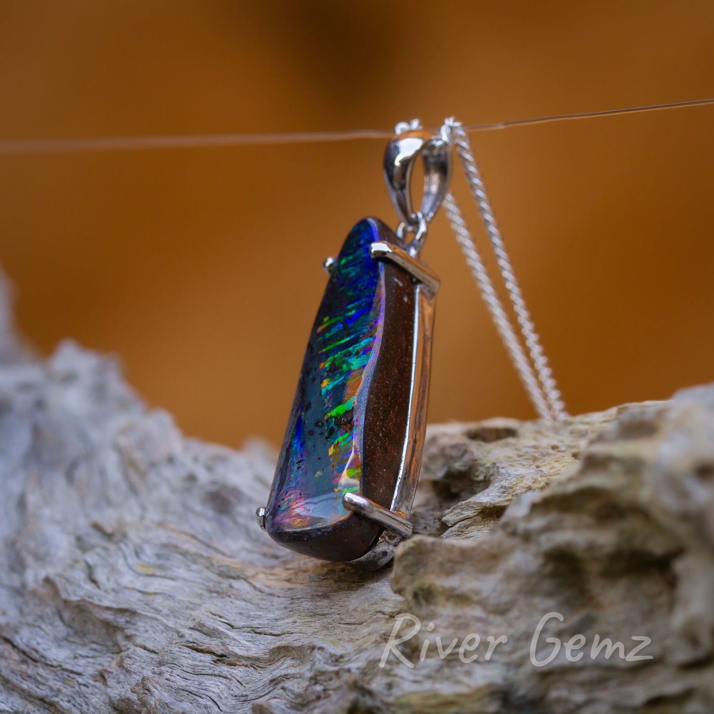 Side view showing good thickness in the free form cut elongated tear drop shaped opal.