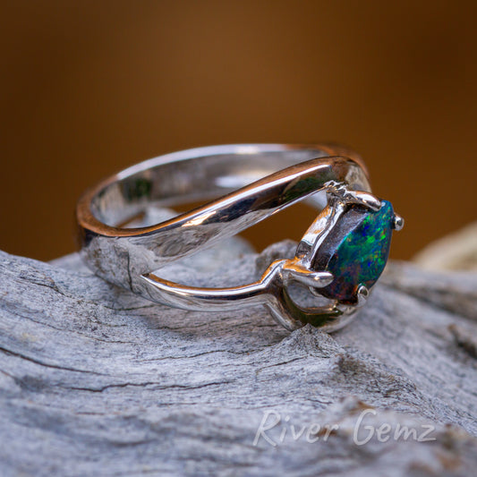 A side on view of the ring shows the ironstone boulder opal together with the unusual silver ring design.