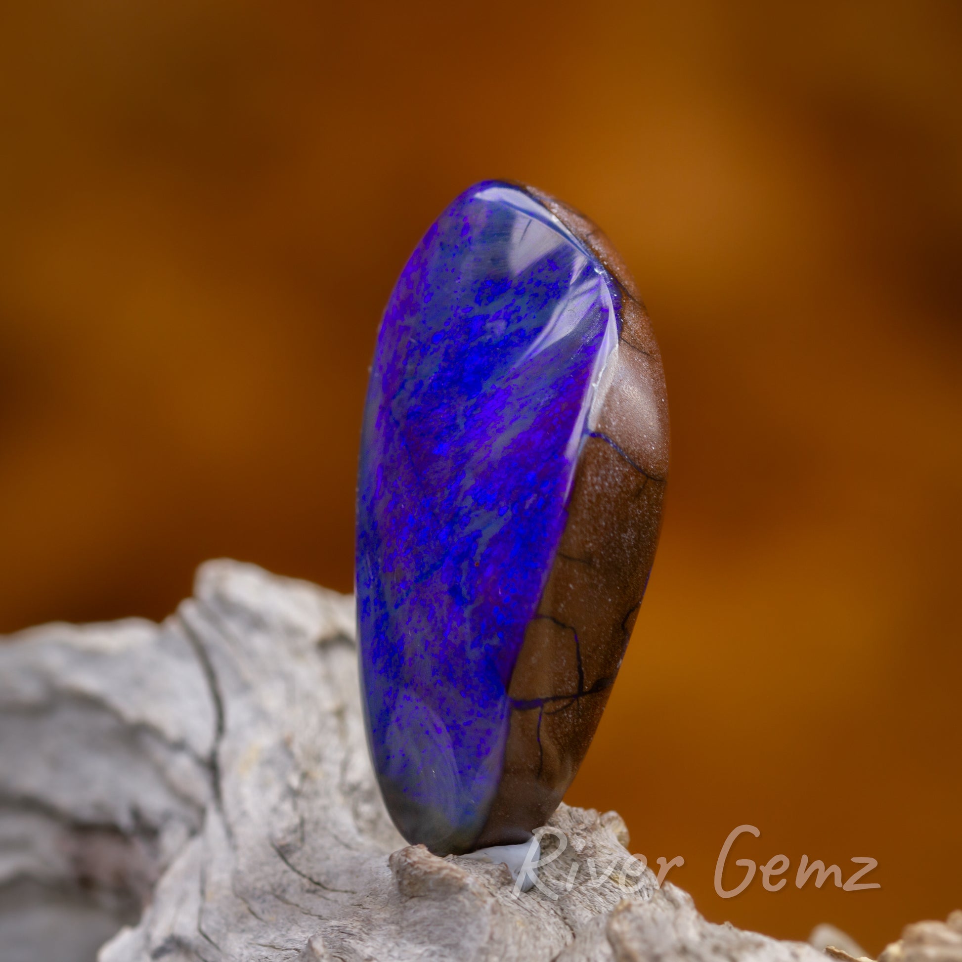 Side on view shows the thickness of the opal and the blue veins passing through the iron stone.