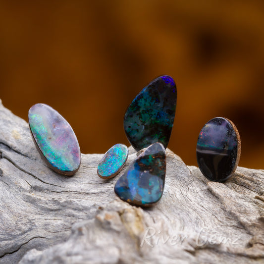 3 green boulder opals, 1 multi-coloured and 1 unusually half black 