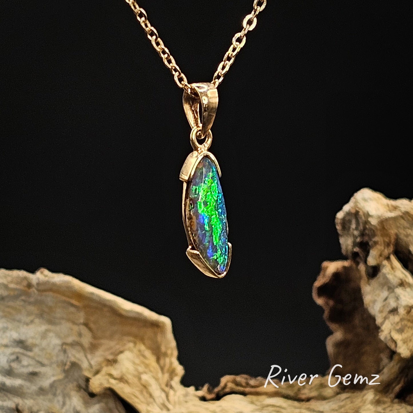 Opal pendant necklace on a chain with a dark background and 'River Gemz' branding.