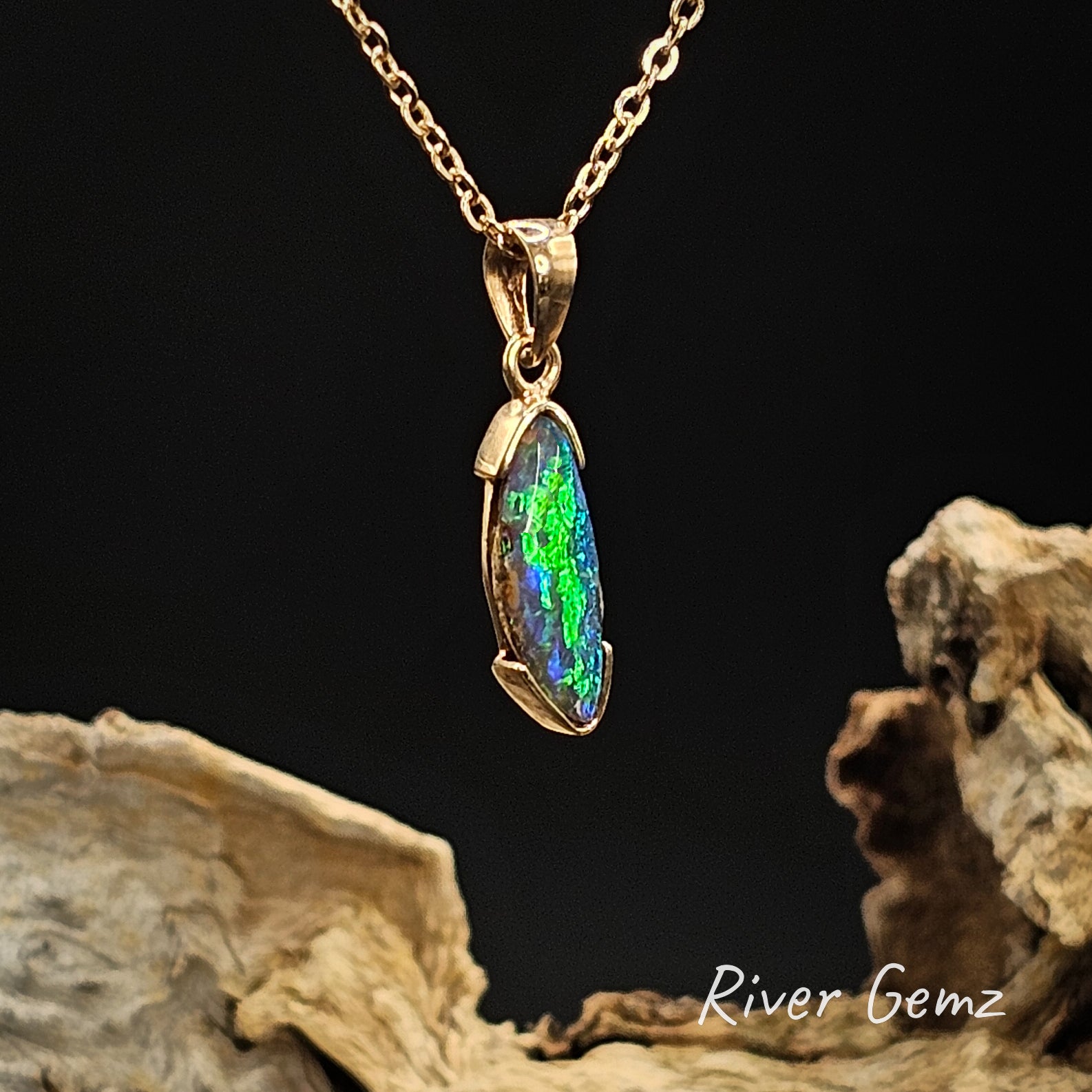 Opal pendant necklace on a chain with a dark background and 'River Gemz' branding.