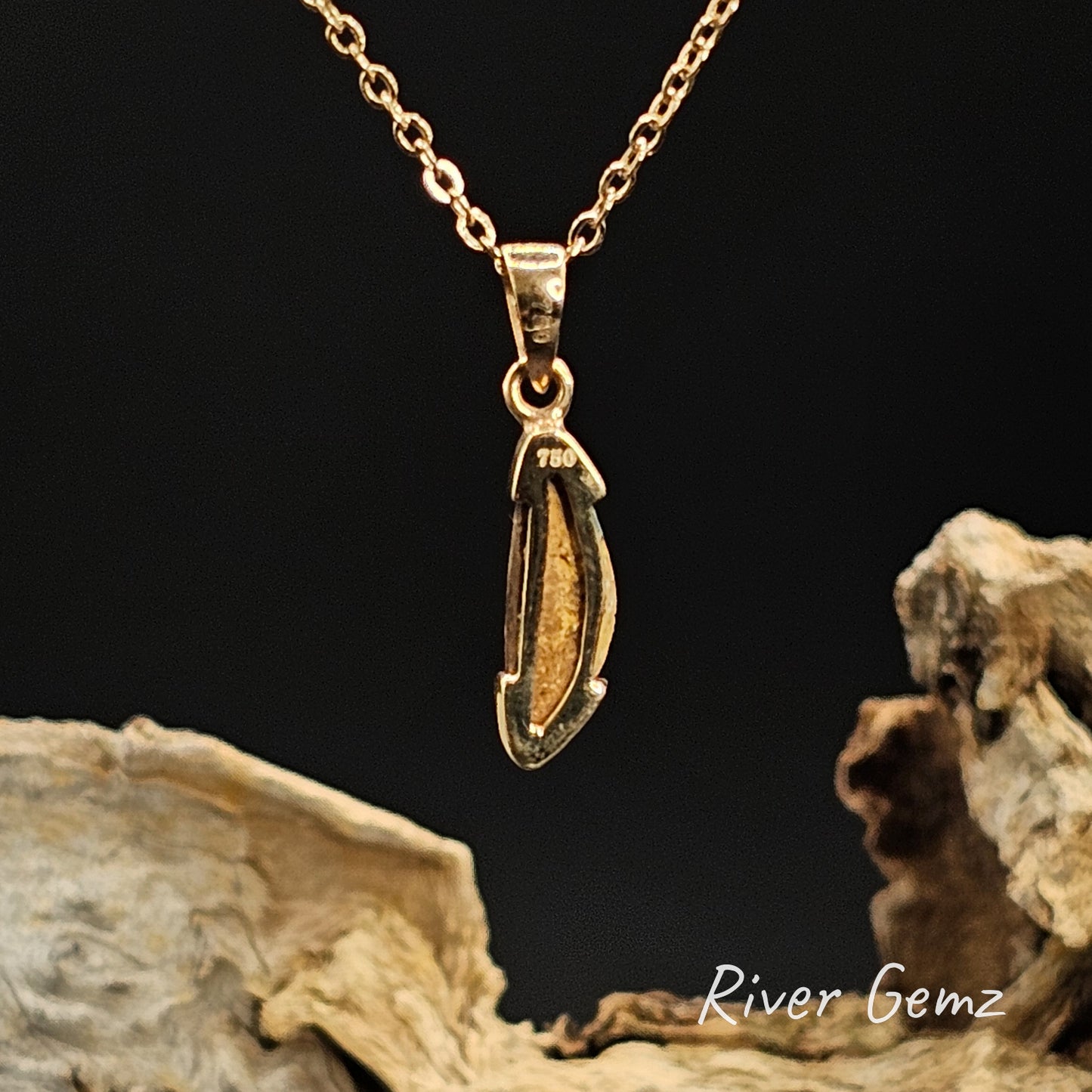 Rear view of gold pendant shows the 750 mark for 18K gold and the sandstone base of the pipe opal.