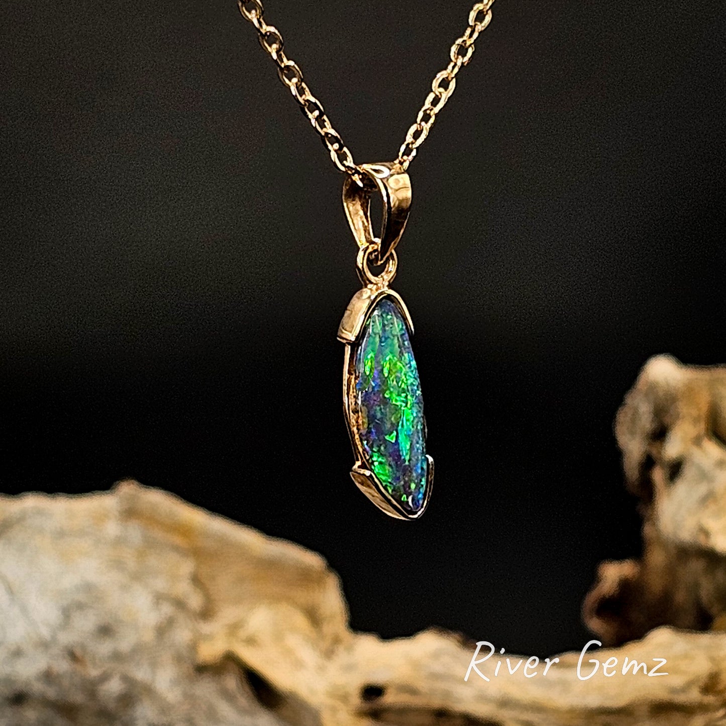 Opal pendant necklace on a gold chain with a dark background and 'River Gemz' branding.
