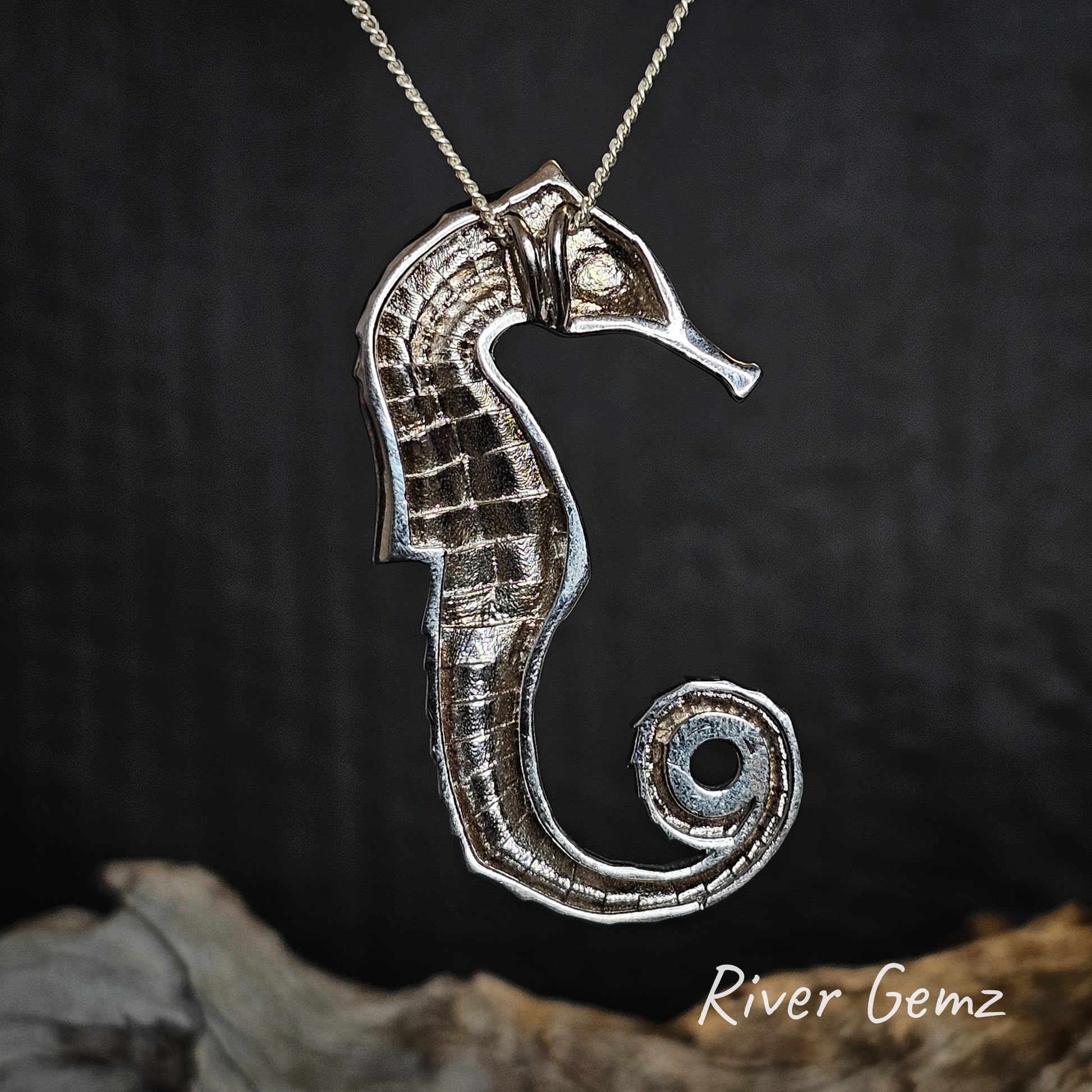 Rear view of silver seahorse pendant on a dark background with 'River Gemz' branding.