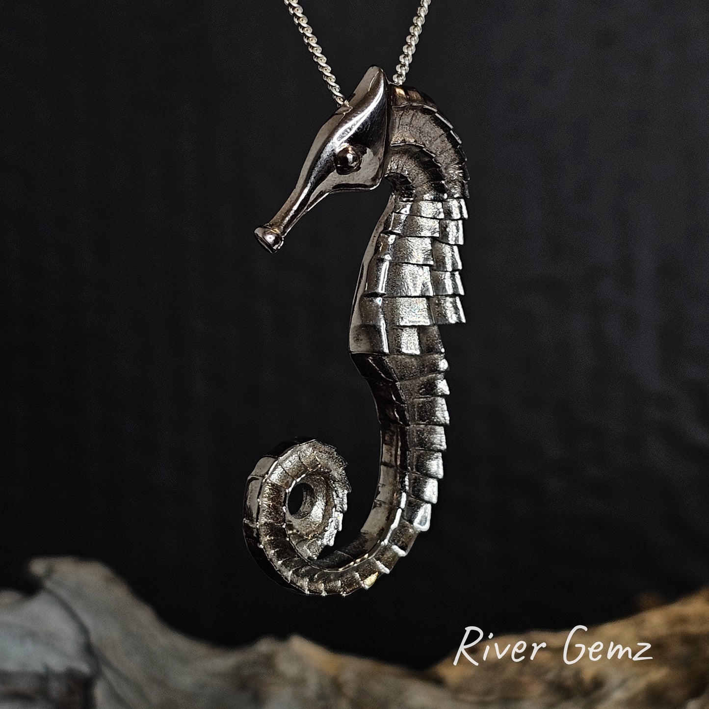 Silver seahorse pendant on a dark background with 'River Gemz' branding.