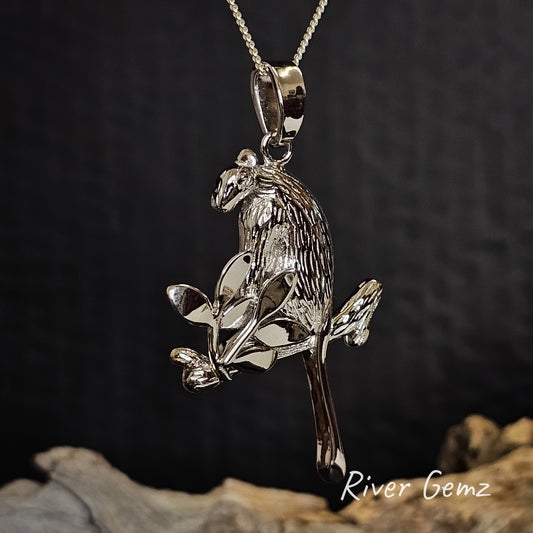 Silver tree kangaroo pendant on a chain with a dark background