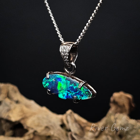 Opal pendant necklace on a dark background with 'River Gemz' branding.