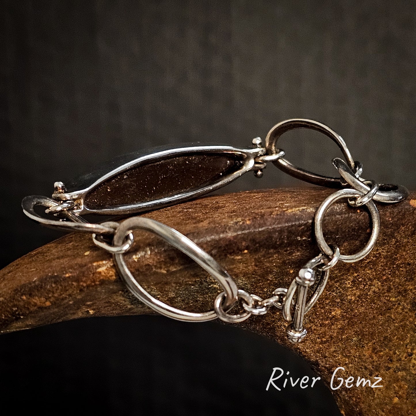 Rear of opal shows the ironstone matrix of the boulder opal. Sterling silver bracelet with large and medium sized links.