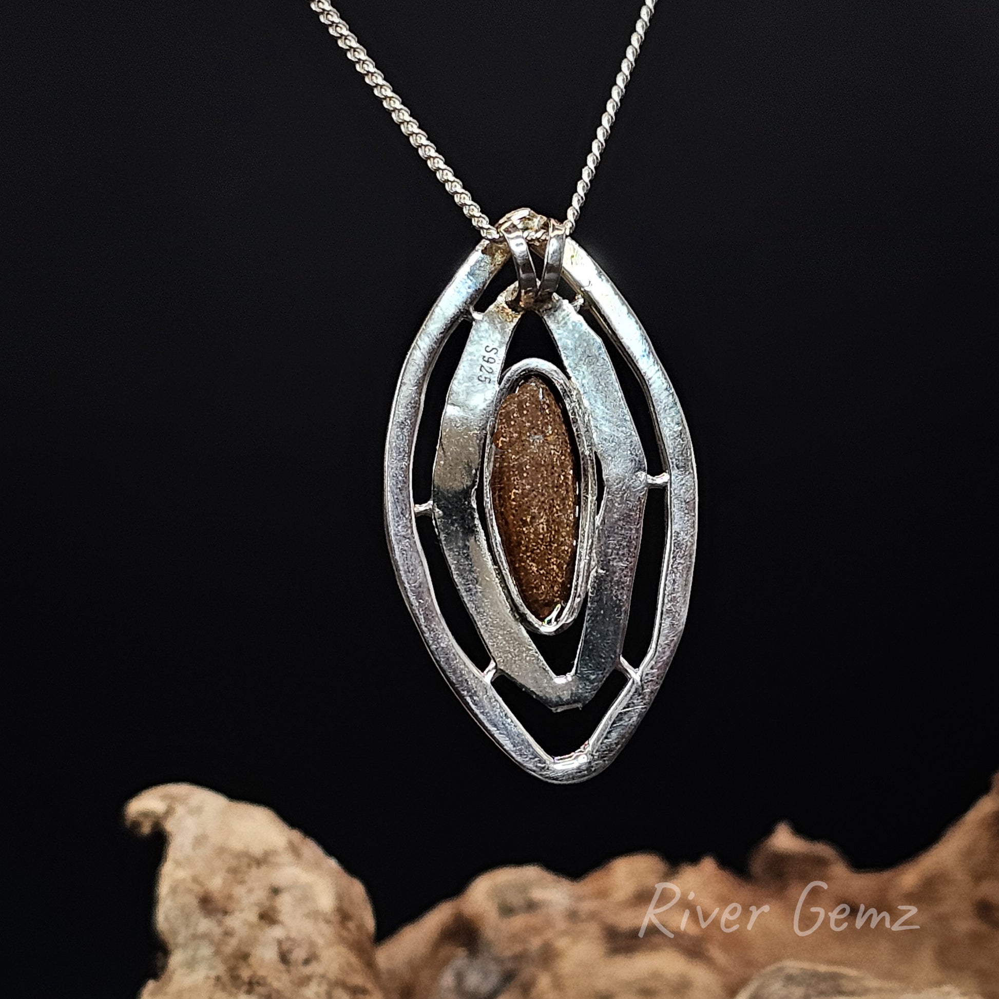 Rear view of the necklace shows the 925 sterling silver hallmark and the ironstone matrix of the boulder opal on a dark background, featuring 'River Gemz' branding.