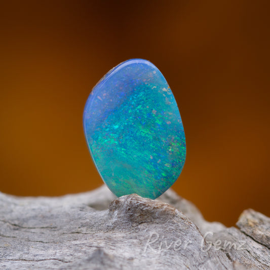 Four sided loose blue-green opal shown standing upright.