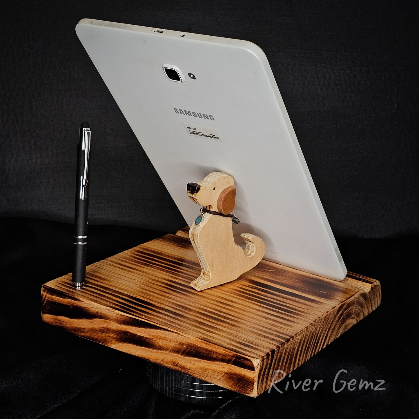 Wooden tablet stand with a dog-shaped phone holder and a Samsung tablet on a dark background.