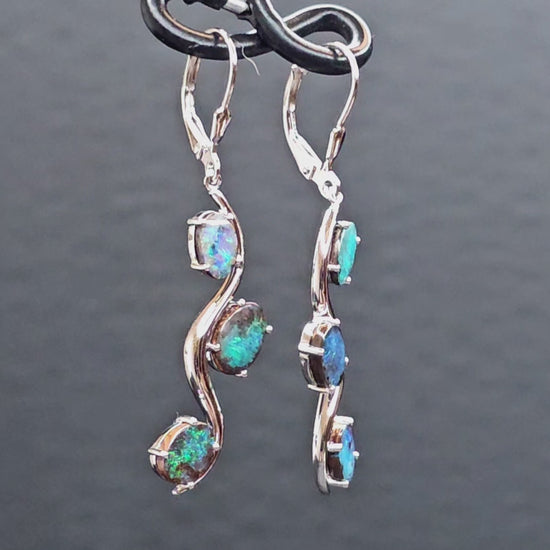 Video showing the sterling silver boulder opal hook earrings rotating 200 degrees to display front and back views.