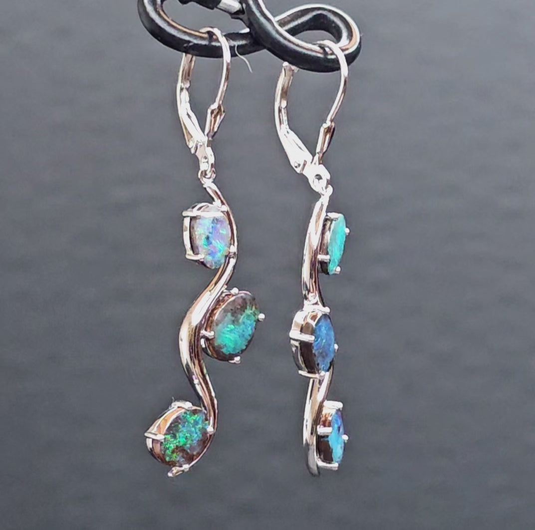 Video showing the sterling silver boulder opal hook earrings rotating 200 degrees to display front and back views.