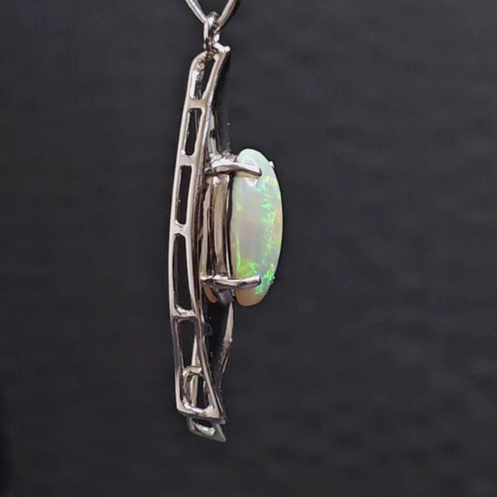 Video showing all sides of the silver opal pendant as it rotates.