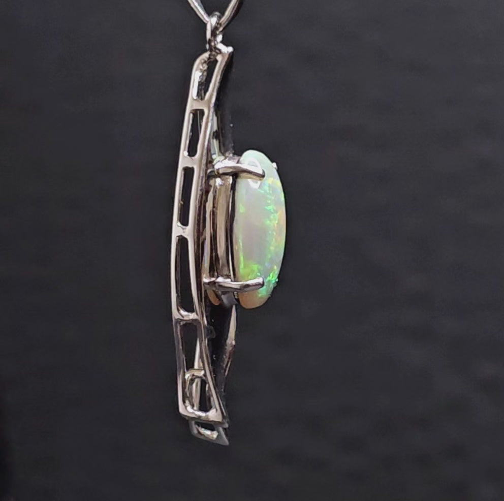 Video showing all sides of the silver opal pendant as it rotates.