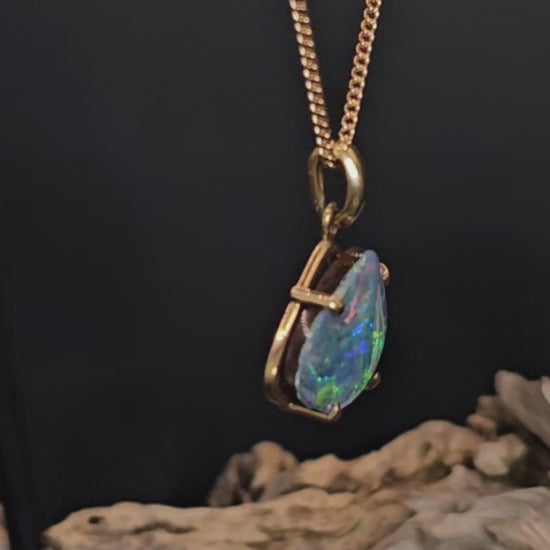 Video showing the boulder opal and gold pendant spin 180 degrees.