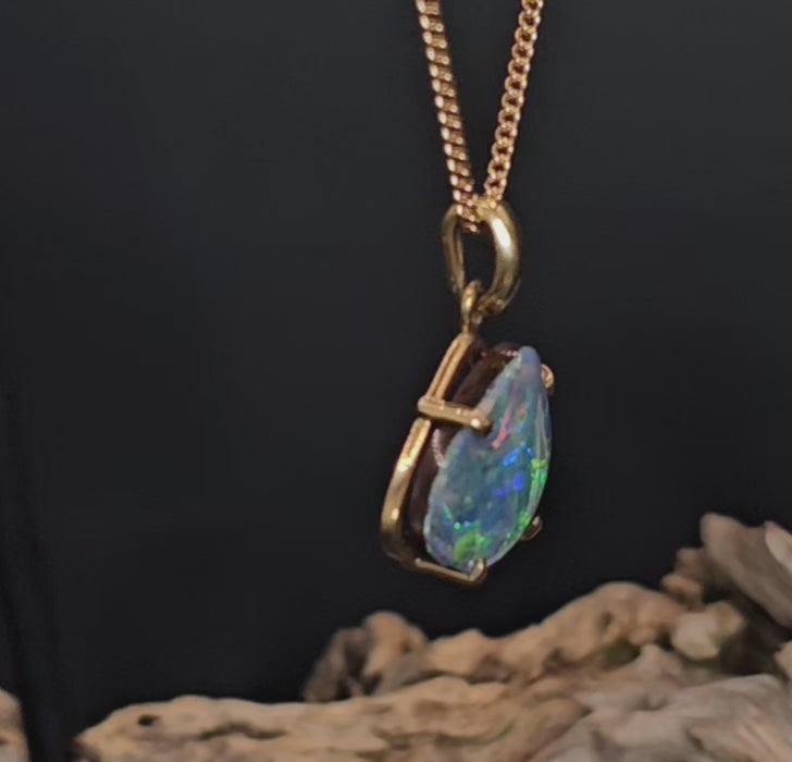 Video showing the boulder opal and gold pendant spin 180 degrees.