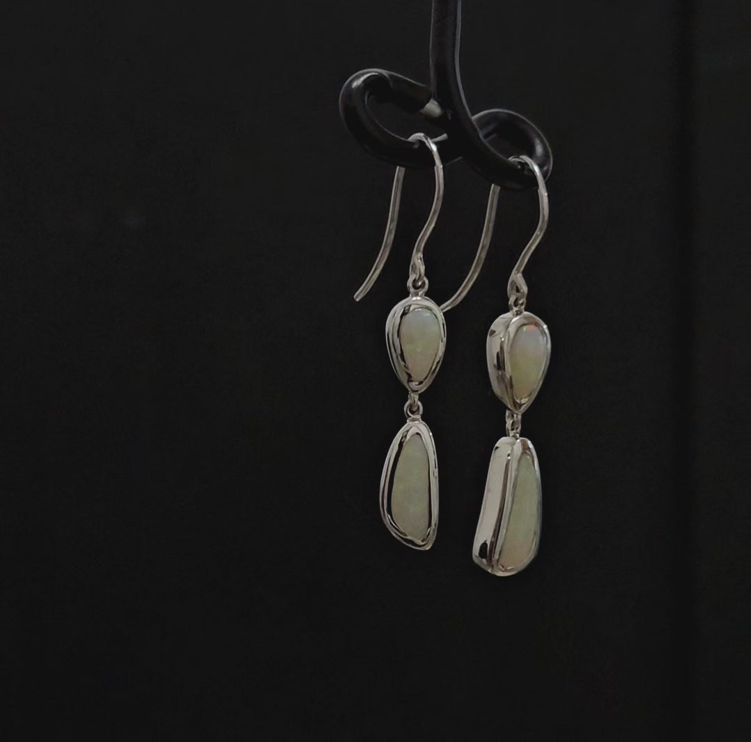 Two milky opals besel set in each silver French hook earring.