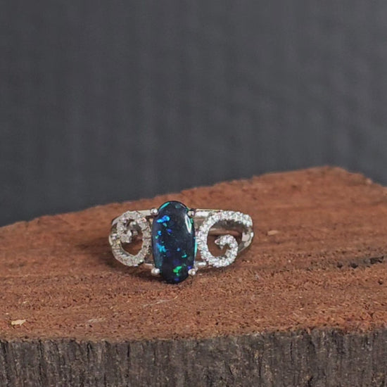 Video showing the white gold, black opal and diamond ring rotate 180 degrees.